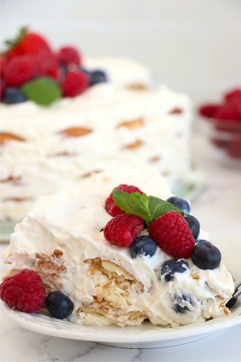 piece of layered cake with berries on top