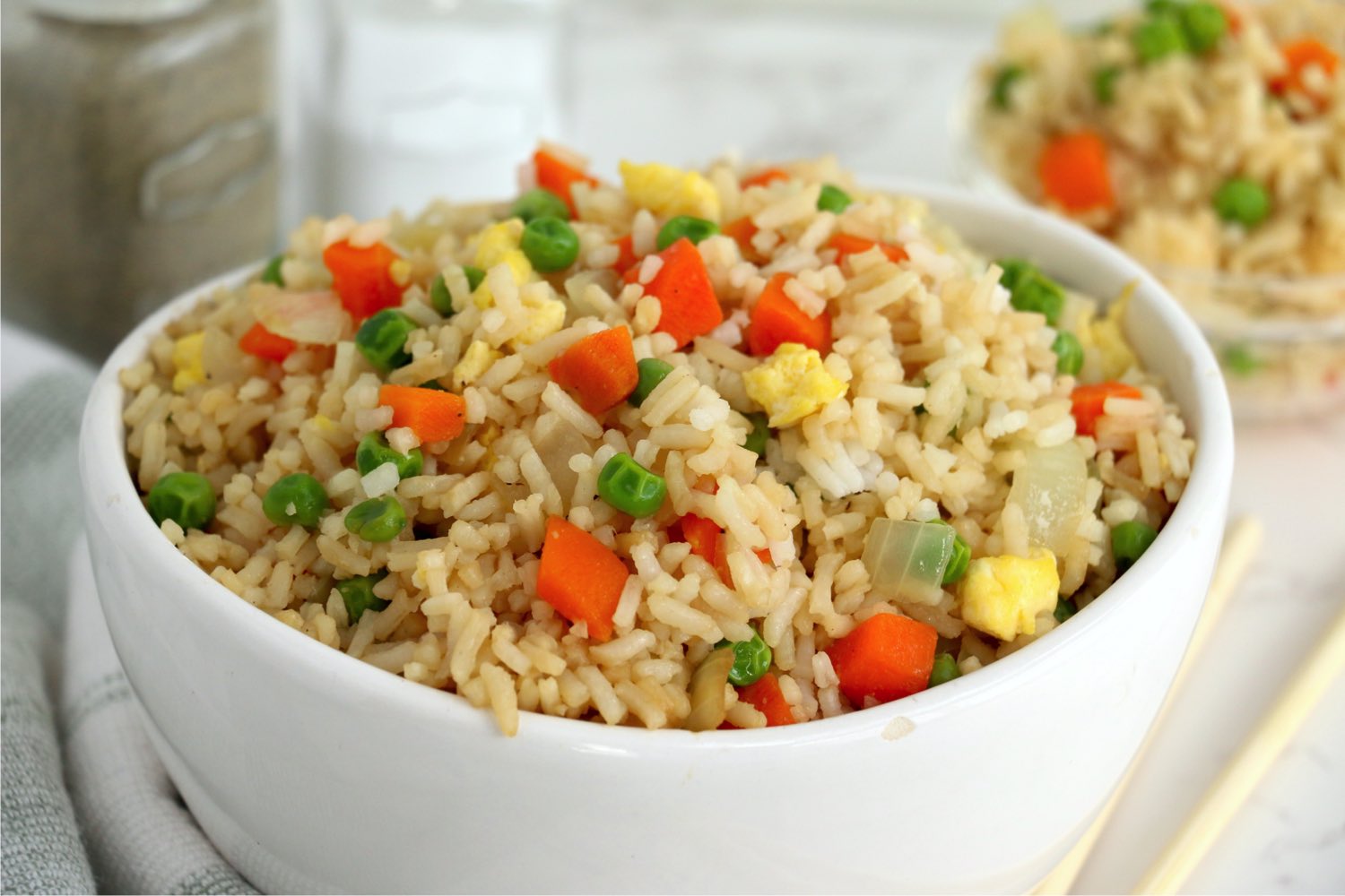 white bowl filled with fried rice and vegetables