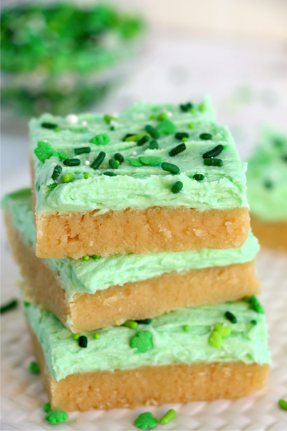 a stack of dessert bars with green frosting