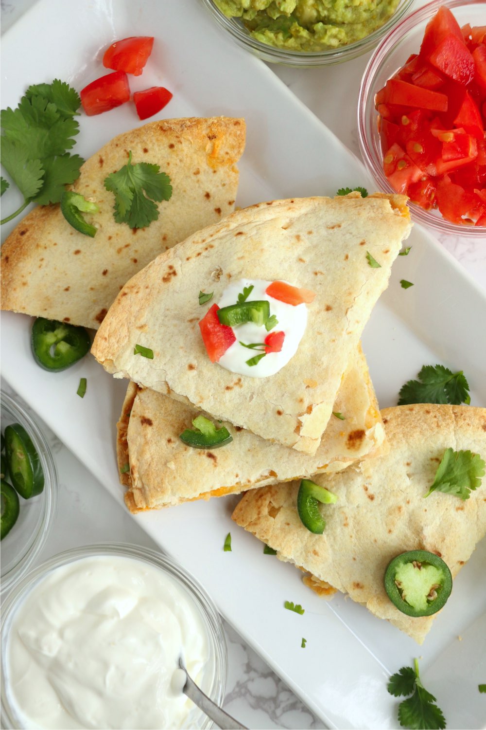 white platter with quesadilla pieces