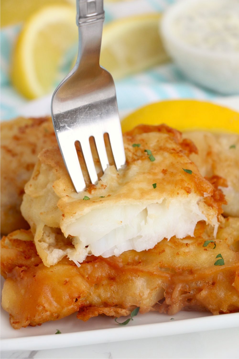 fork going into a fried fish fillet