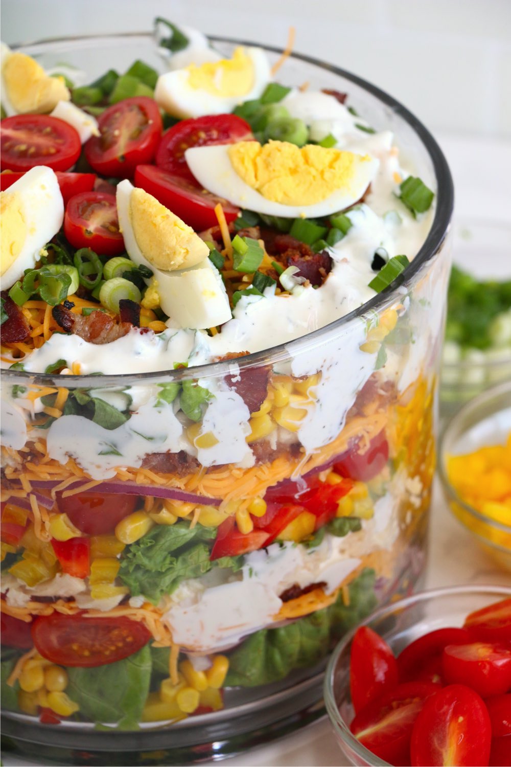 up close shot of the side of a trifle bowl filled with salad