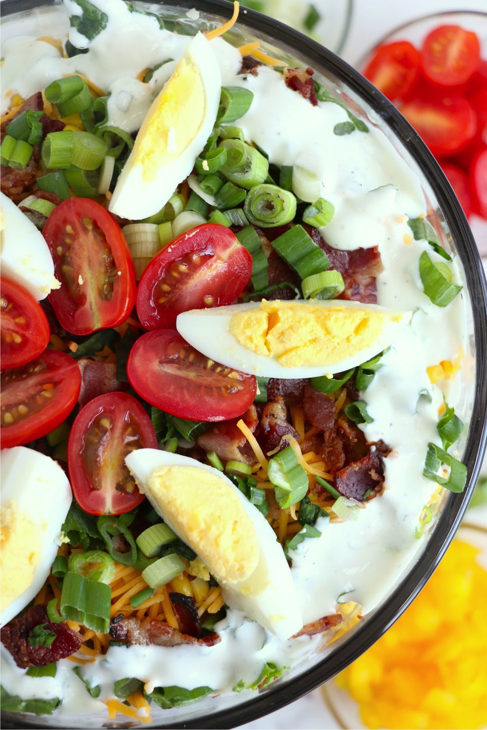 top view of layered salad with eggs and tomatoes