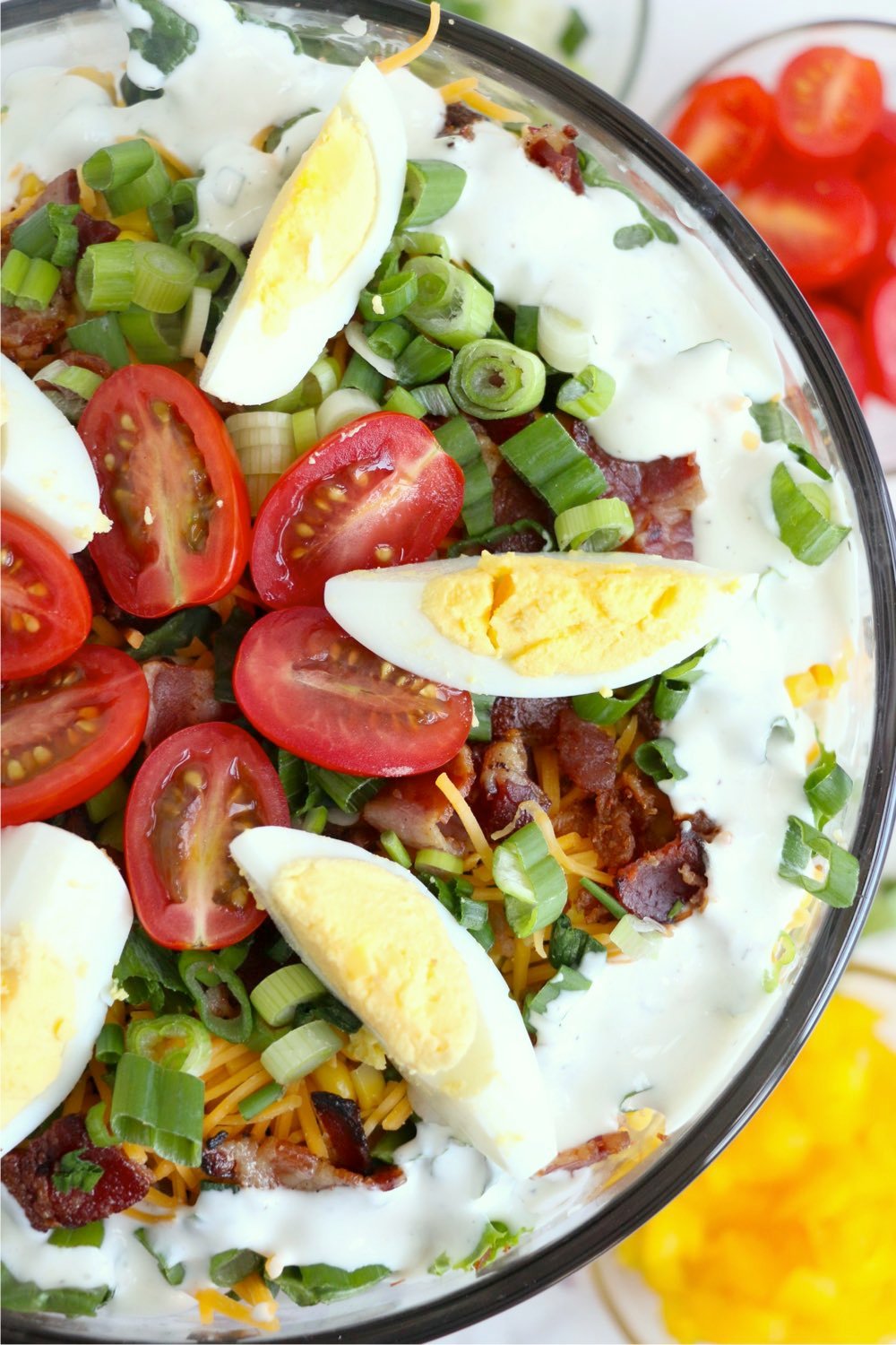 top view of layered salad with eggs and tomatoes