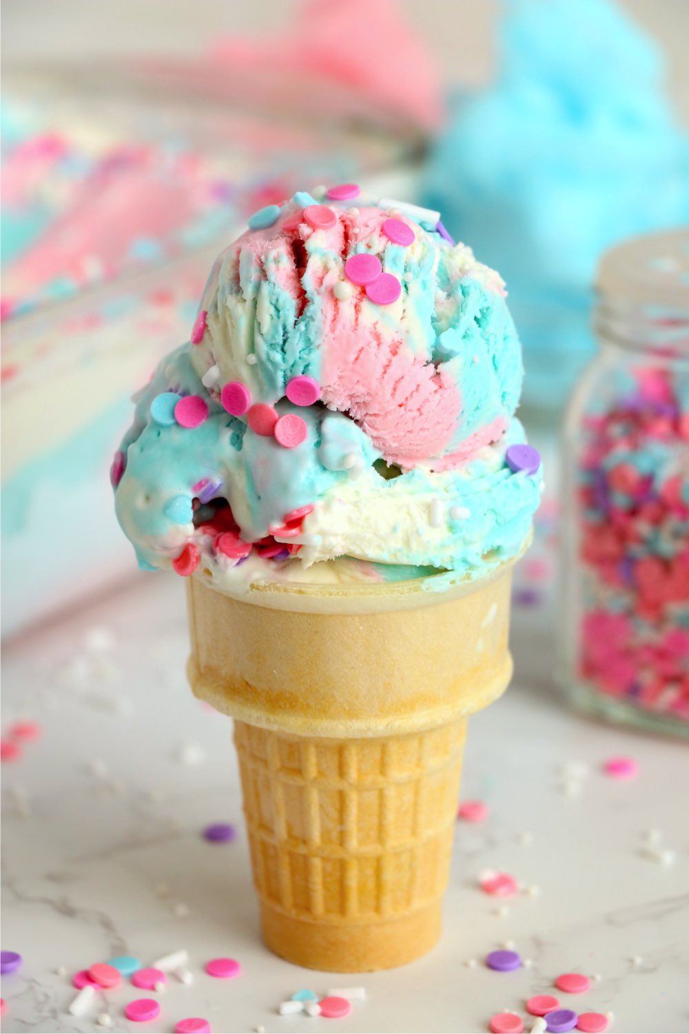 ice cream cone with colorful ice cream and sprinkles