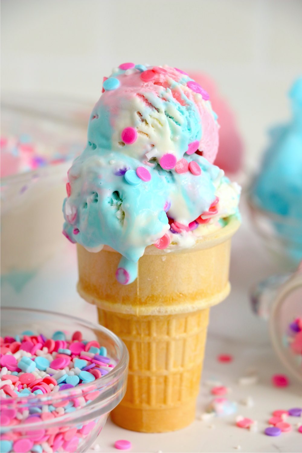 dripping cotton candy ice cream in a cone