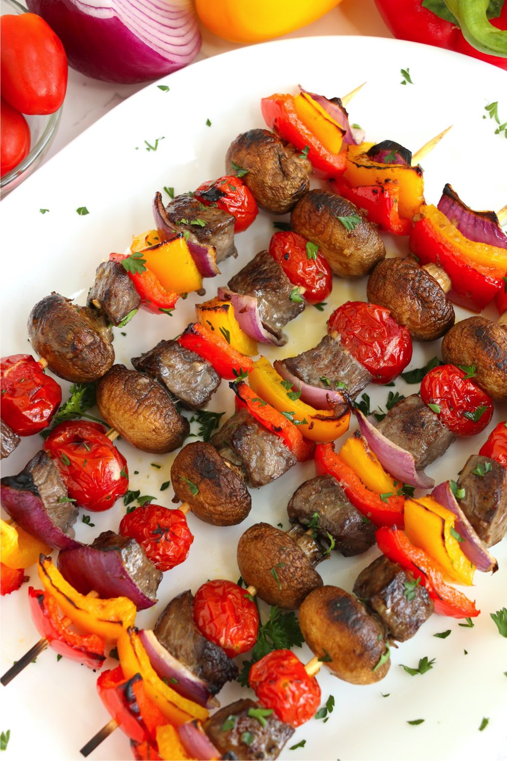 colorful kabobs on a white platter