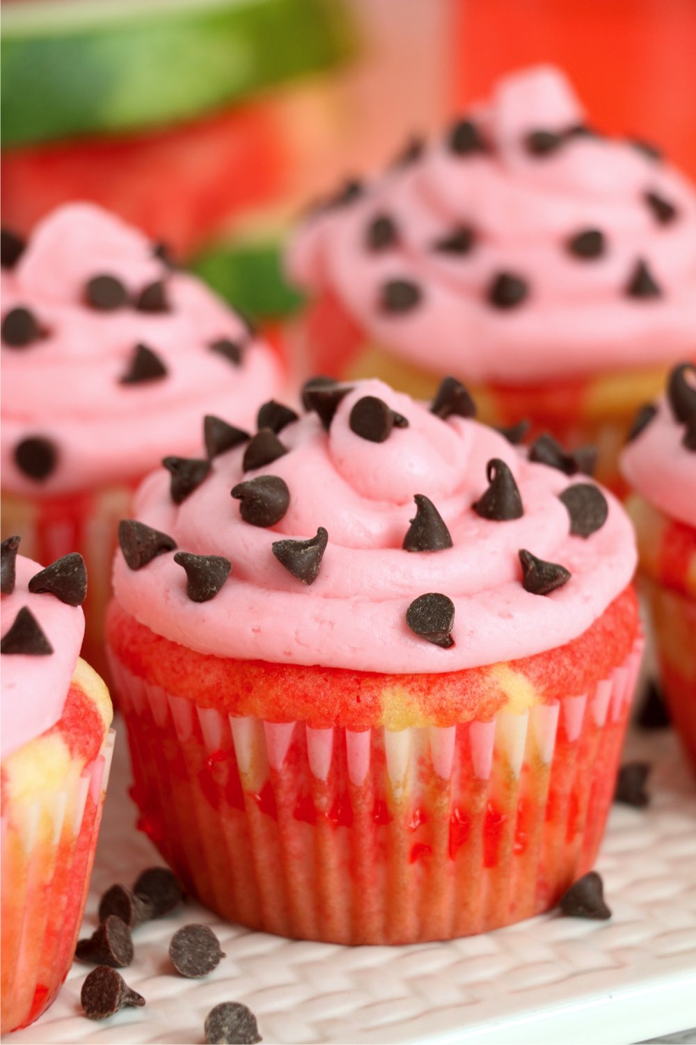 close up of watermelon cupcakes with frosting
