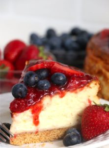 piece of cheesecake covered in berries