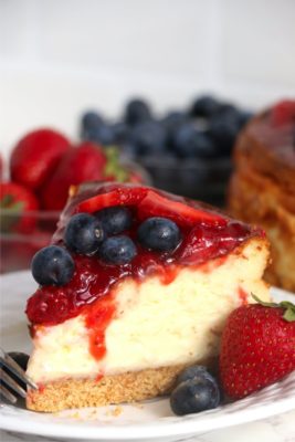 piece of cheesecake covered in berries