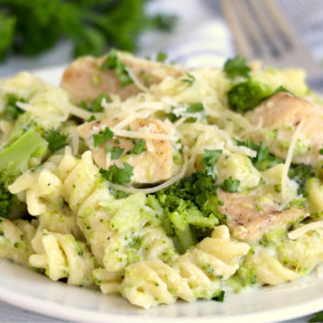 plate of rotini, chicken and broccoli with Parmesan cheese garnish