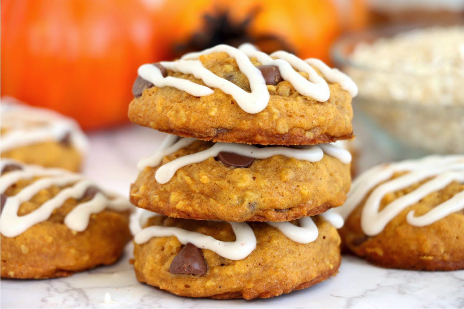 a stack of three pumpkin cookies