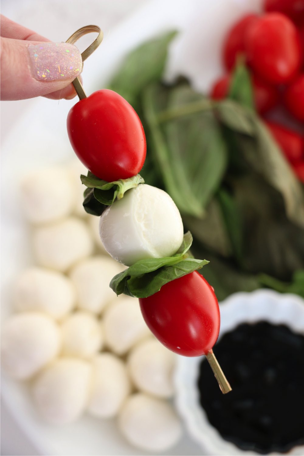 skewer filled with cherry tomatoes, basil and mozzarella