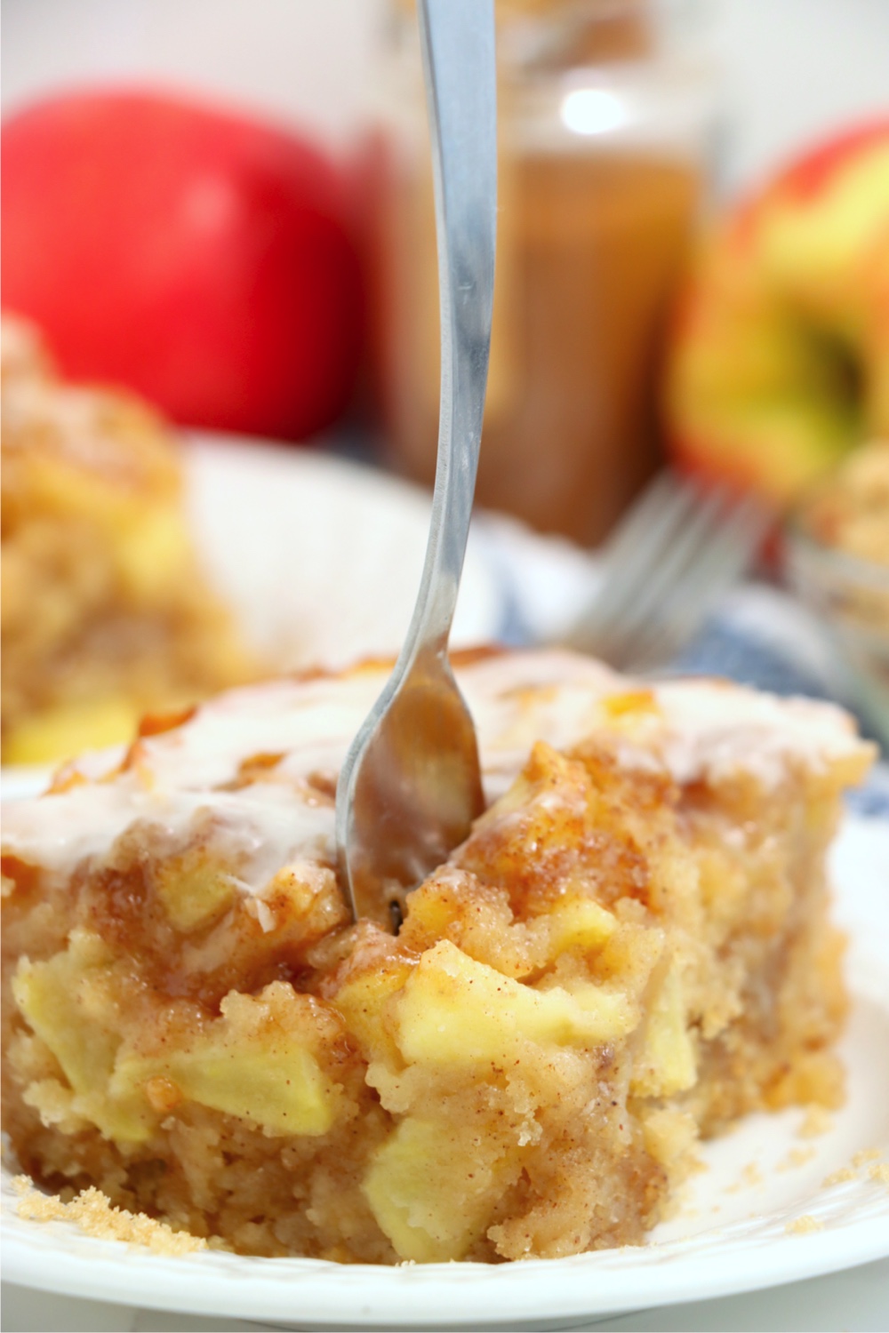 fork digging into piece of apple cake