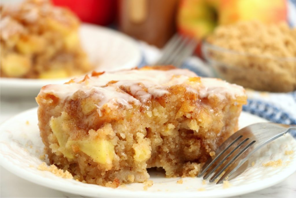 piece of apple cake with fork on plate