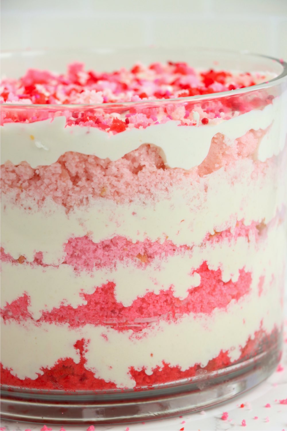 close up of glass trifle bowl filled with pink ombre cake