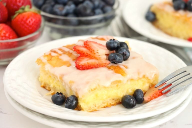 fruit topped cheese danish on a white plate