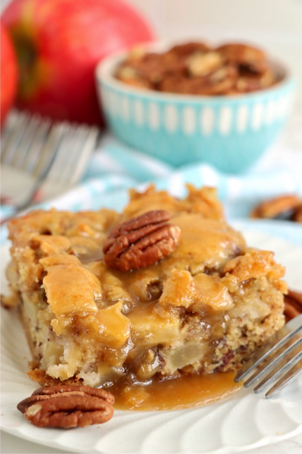 close up of a piece of apple cake with a pecan on top