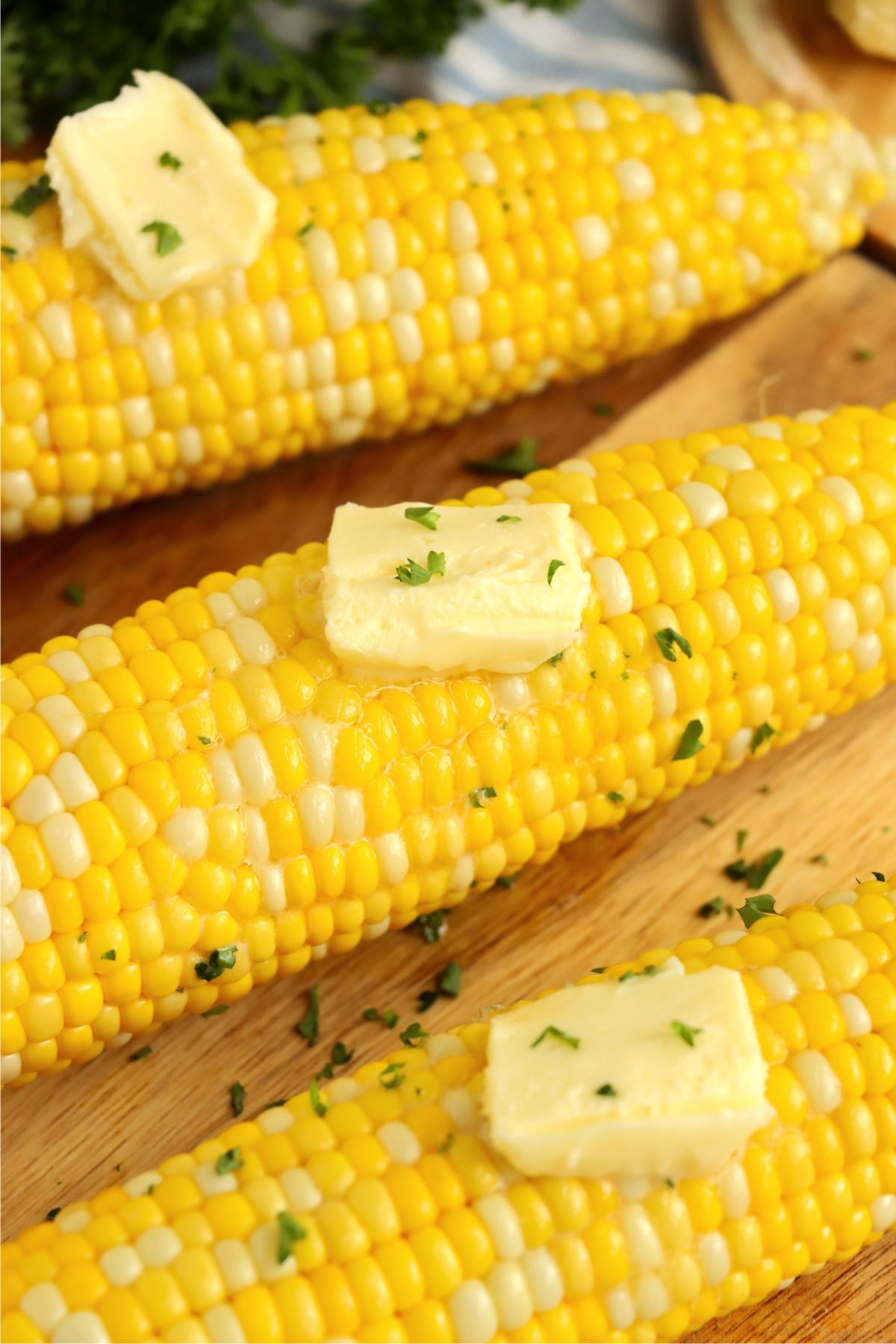 Pats of butter on cooked corn