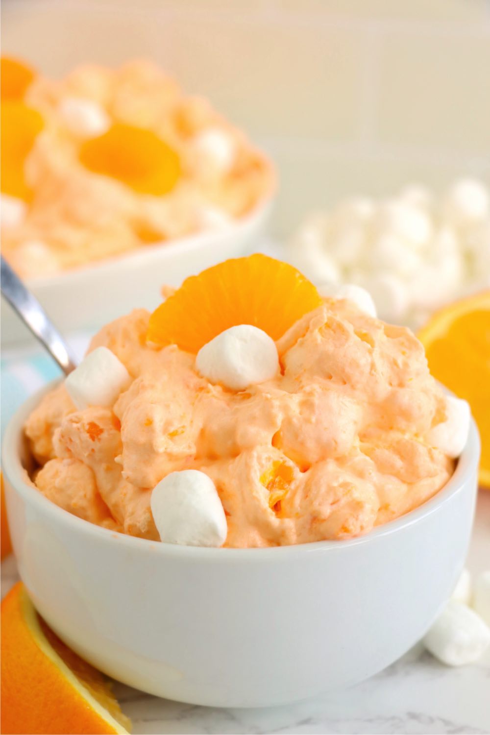 bowl of orange creamsicle salad with fresh oranges and marshmallows