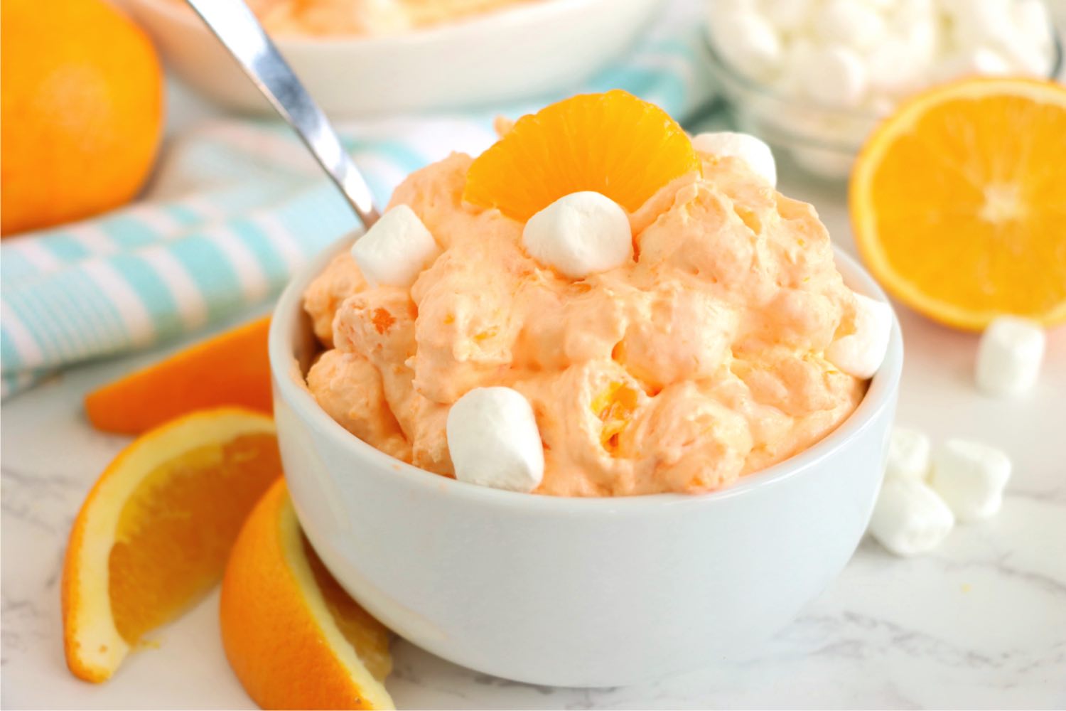 white bowl filled with orange fluff with a spoon