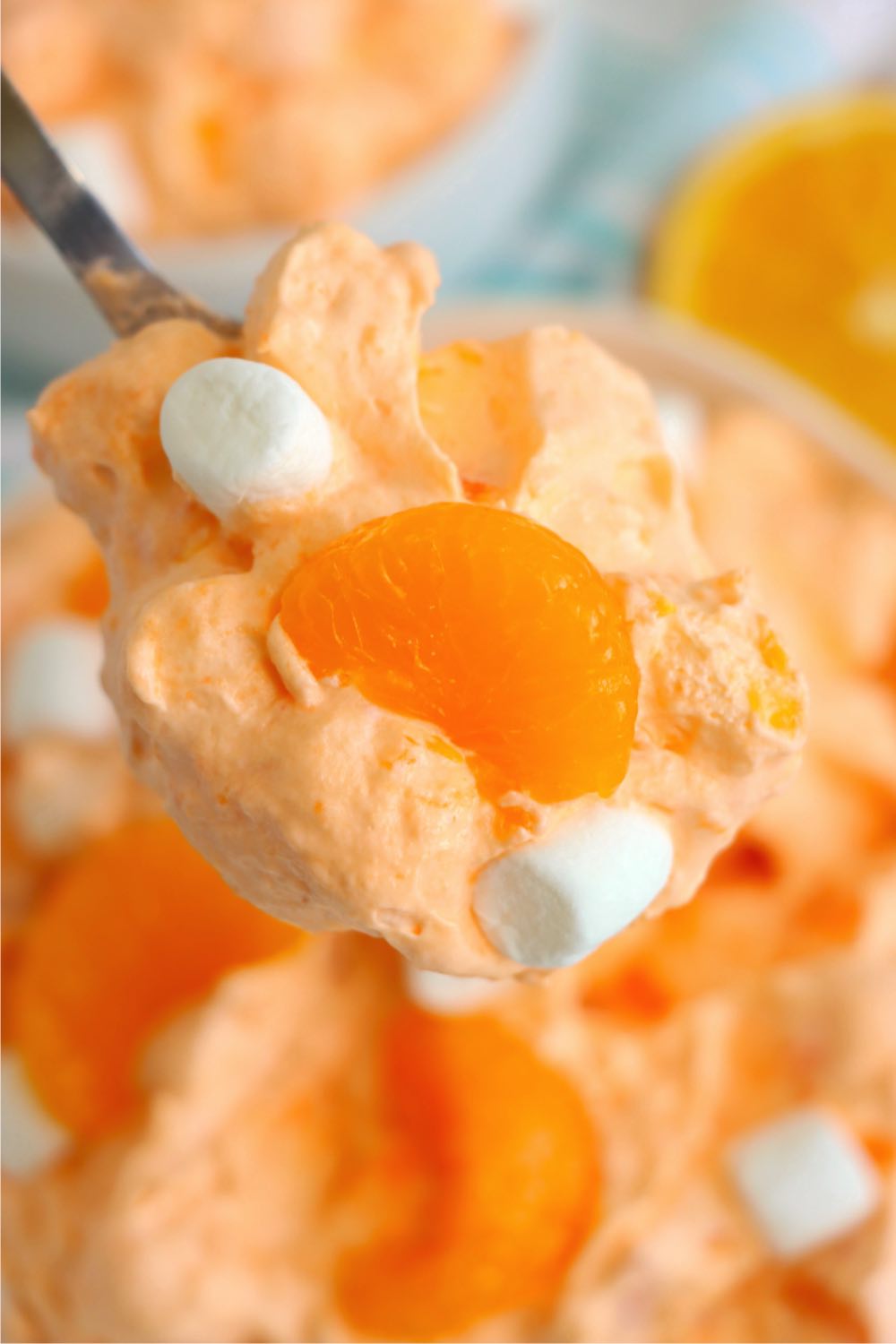 spoon filled with orange creamsicle salad