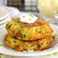 small stack of zucchini patties on a white plate