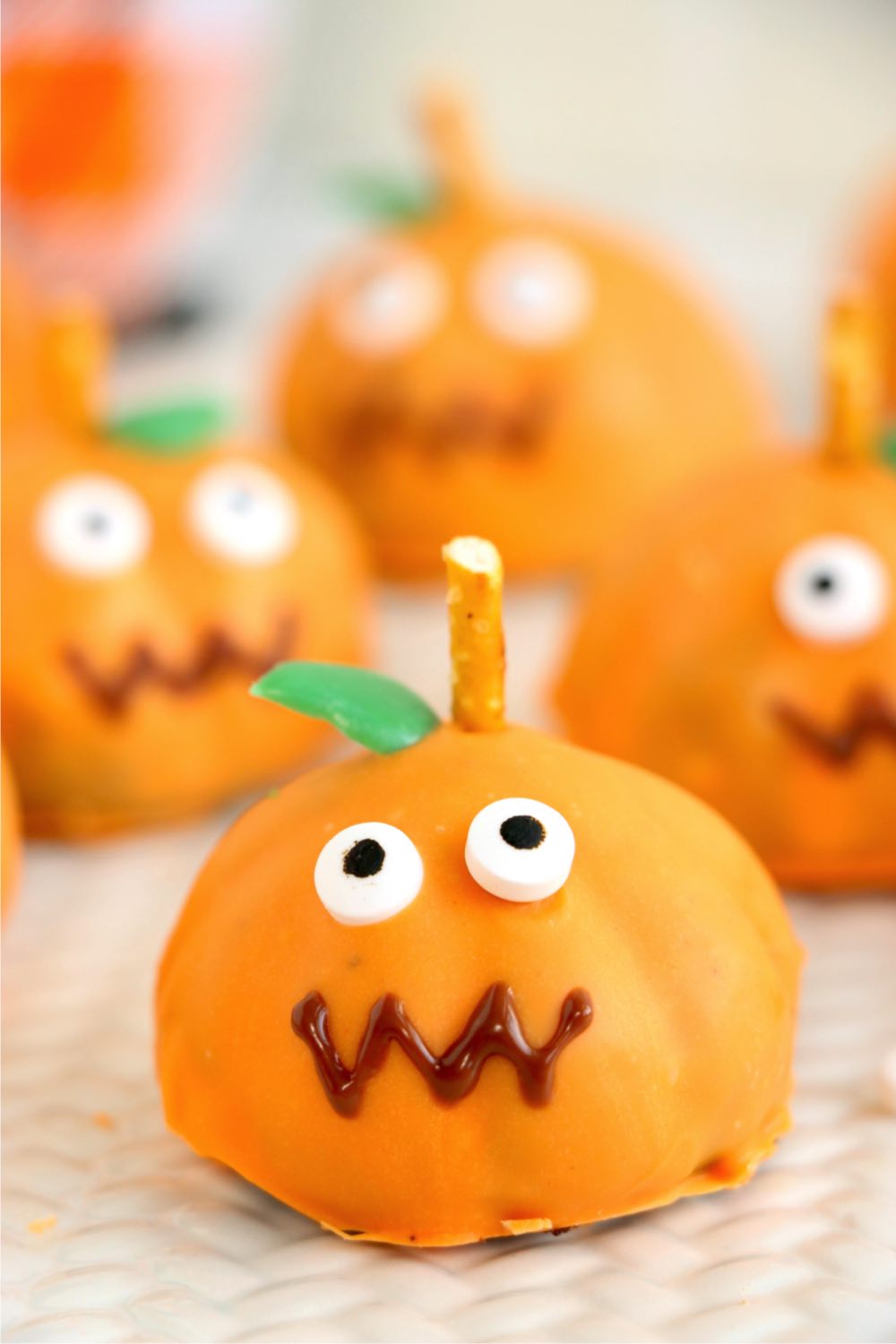 Pumpkin shaped truffle ball with eyes, stem and leaf