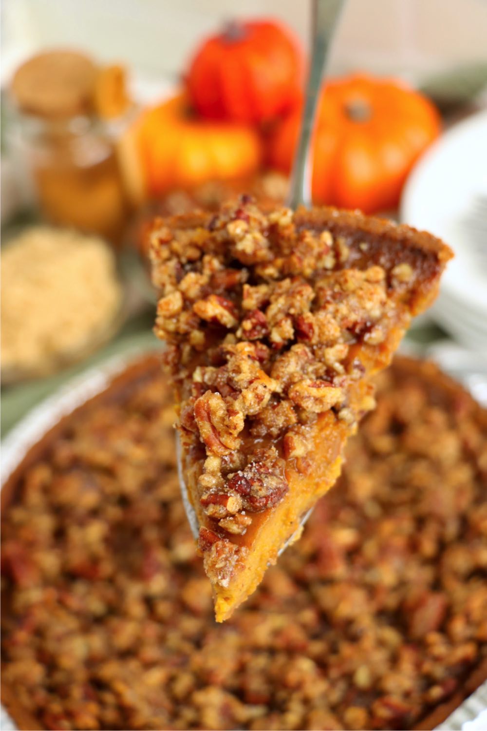 piece of pumpkin pie with nuts on a spatula