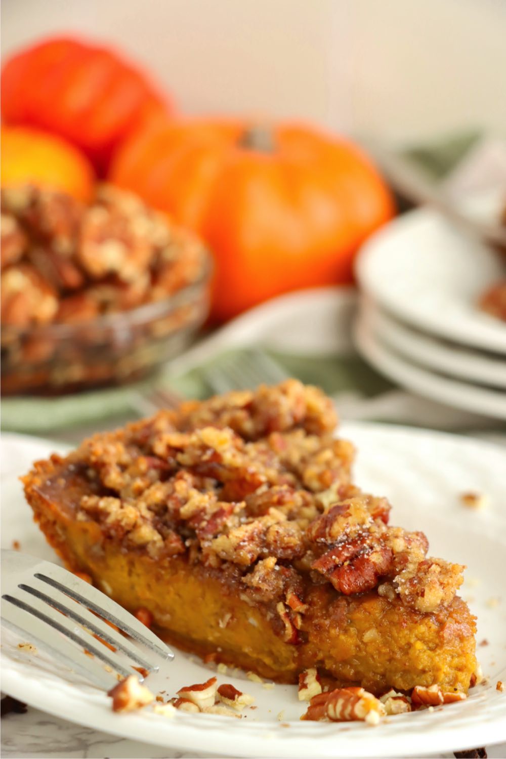 piece of pecan pumpkin pie on plate with fork
