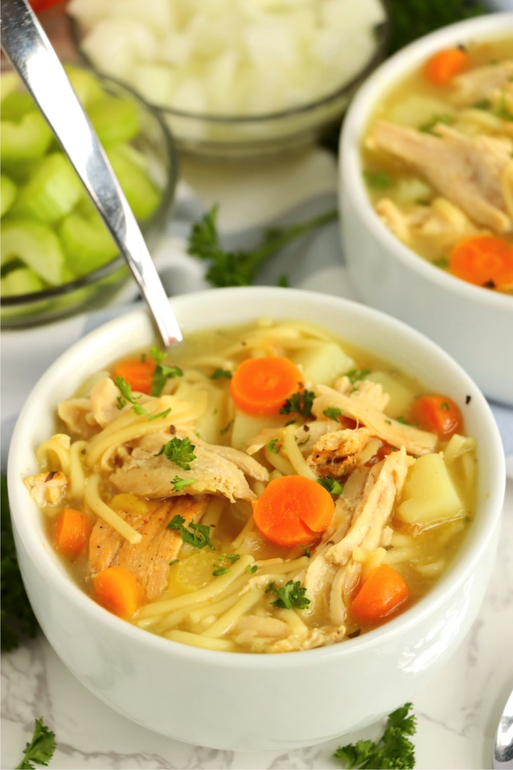turkey and vegetable soup in a white bowl