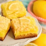 lemon bars on white dessert pedestal