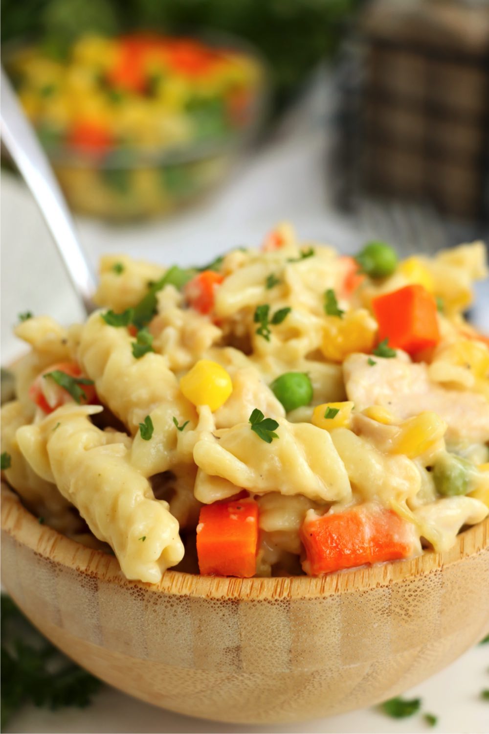 up close shot of rotini pasta mixed with vegetables in a bowl