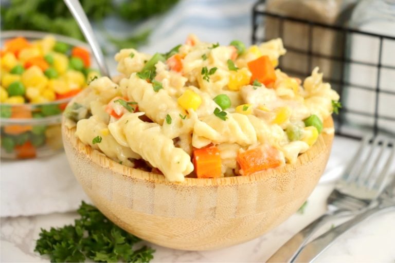 wooden bowl filled with pasta and vegetables