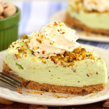 Piece of pistachio cheesecake on a white plate