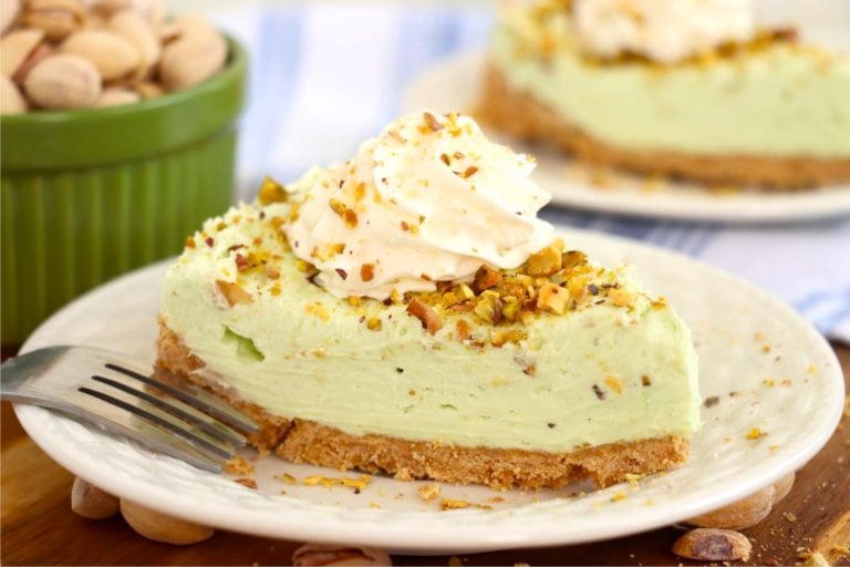 Piece of pistachio cheesecake on a white plate