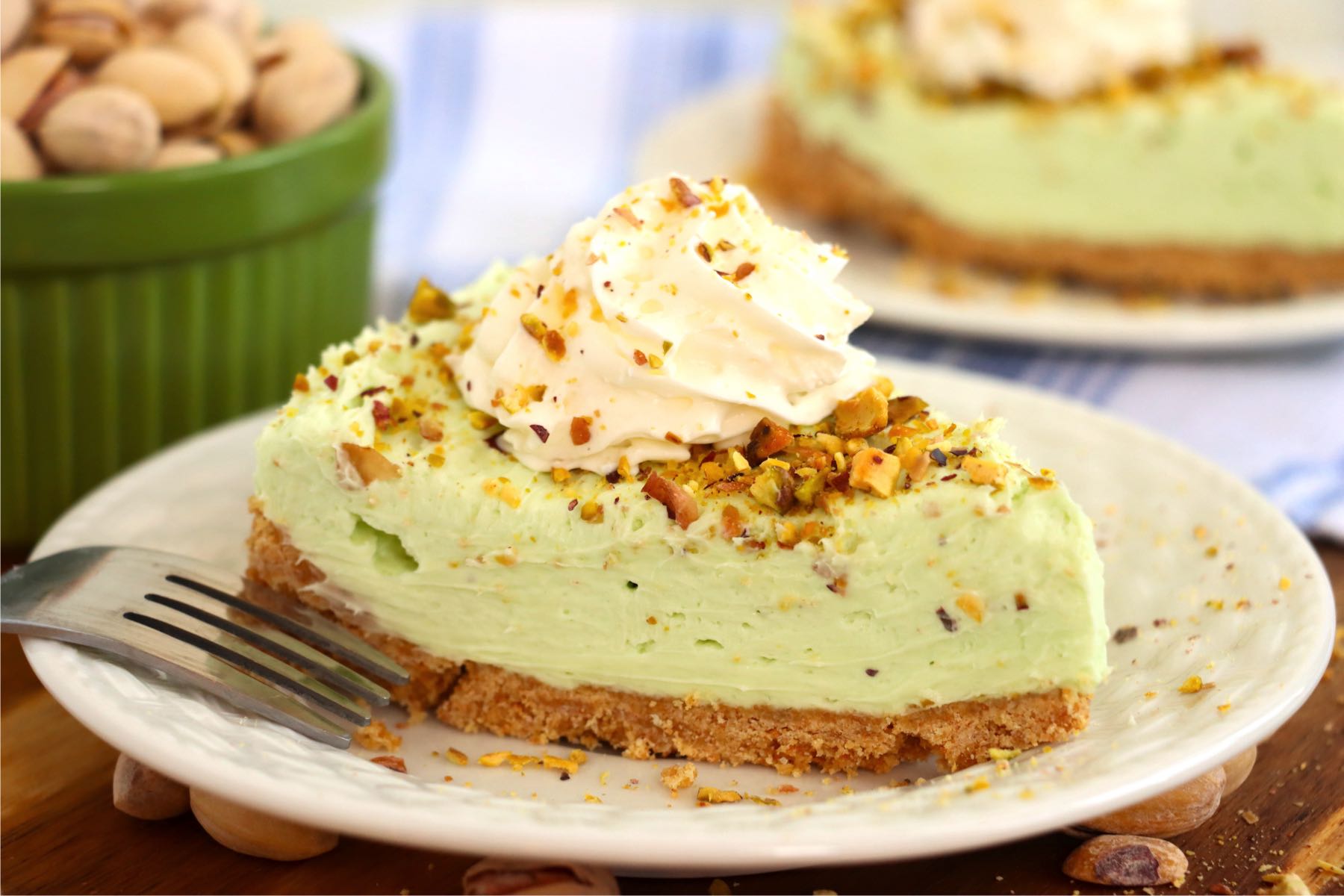Piece of pistachio cheesecake on a white plate