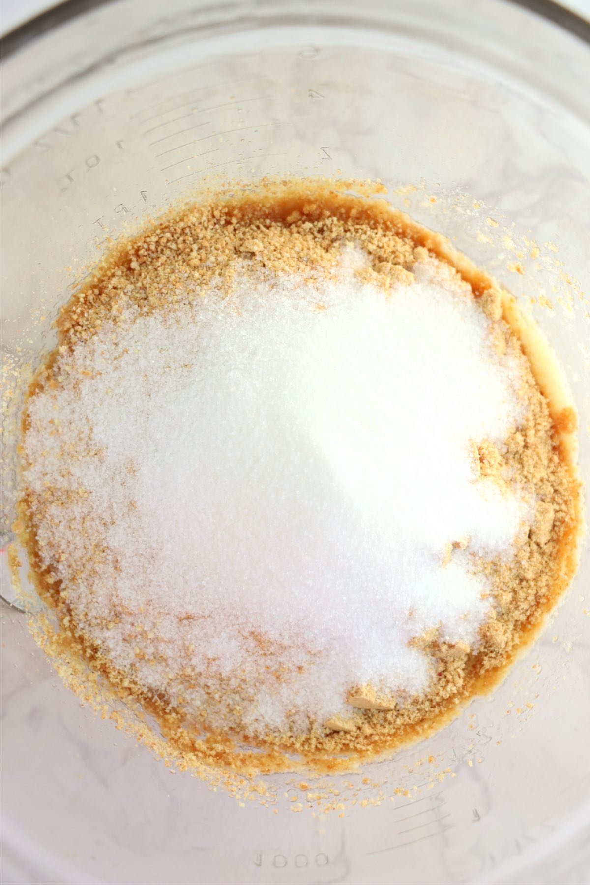 Graham cracker crumbs, sugar and melted butter in a glass mixing bowl