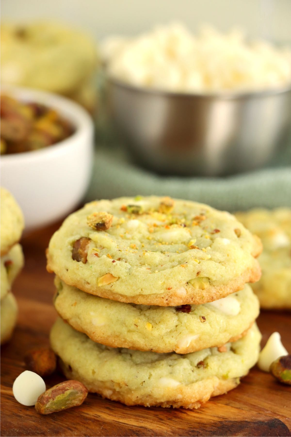 Stack of three pistachio pudding cookies in front of other ingredients