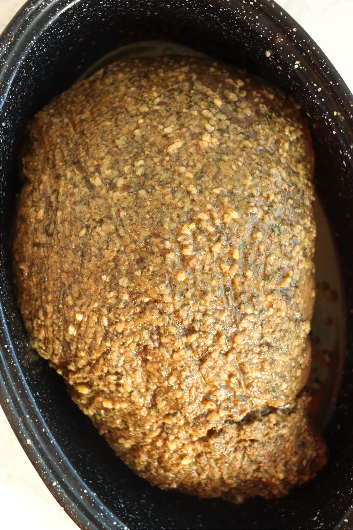 Sirloin tip roast rubbed with spices in a baking pan