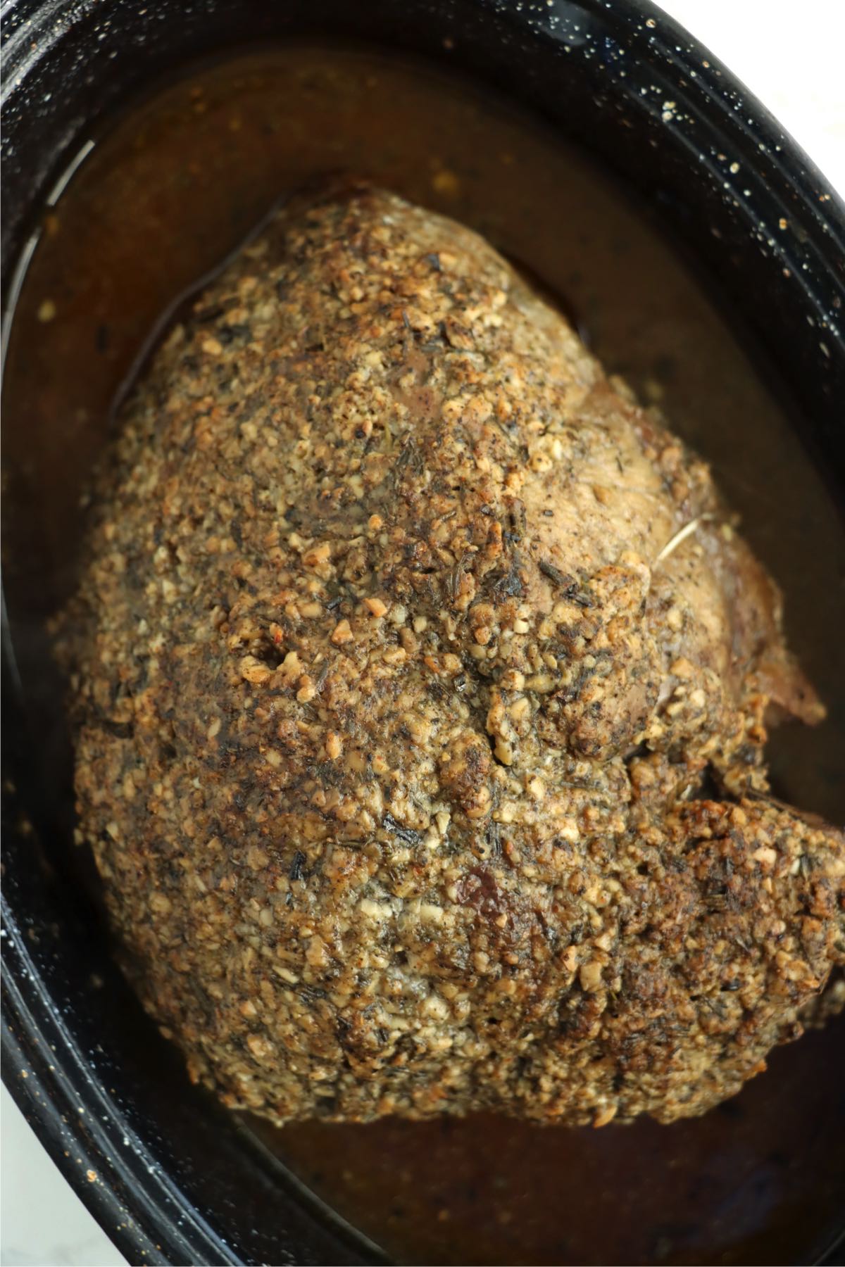 Cooked sirloin tip roast in a baking pan