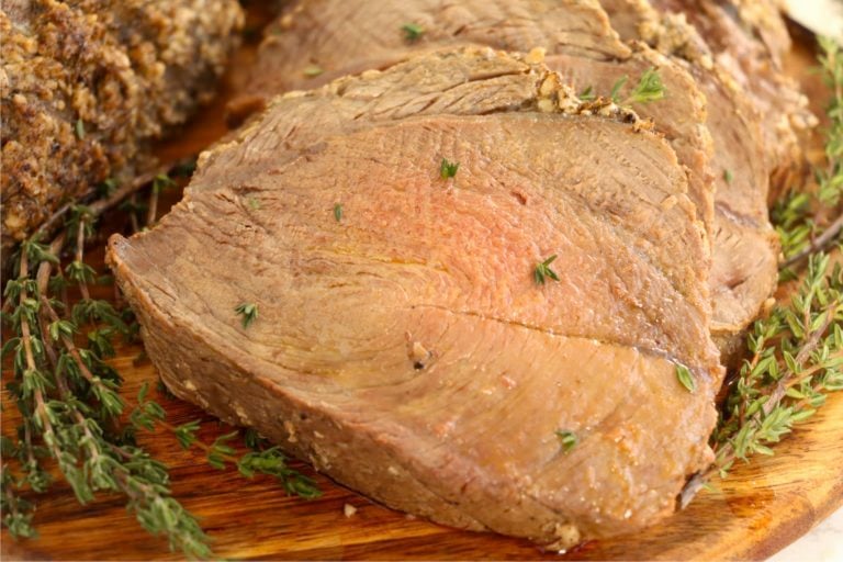 sliced pieces of prime rib on wooden cutting board