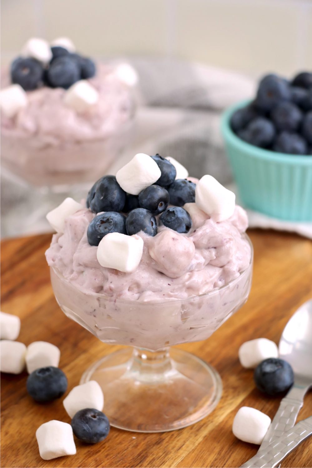 small glass dessert dish filled with blueberry fluff salad