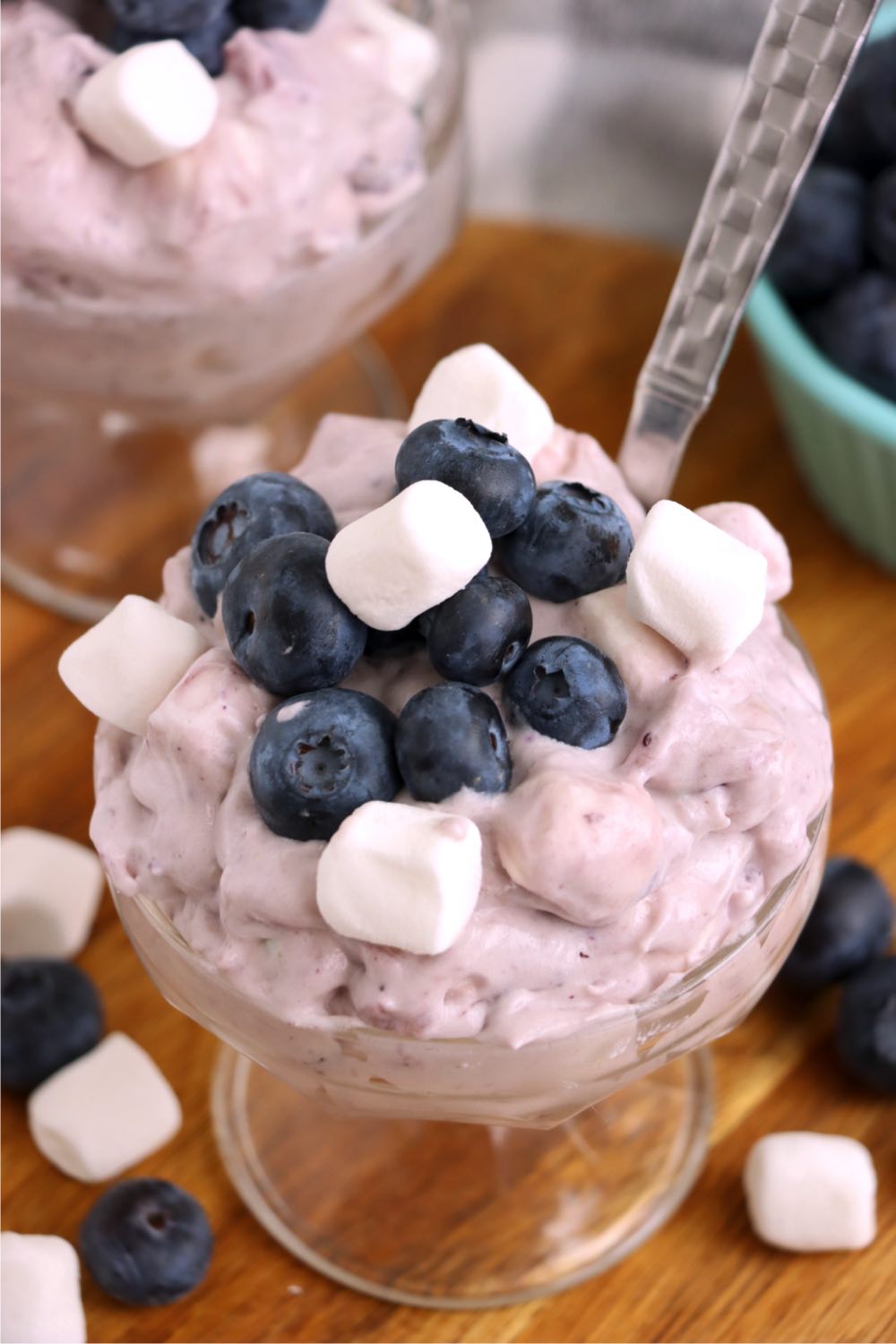 glass dessert cup filled with blueberry fluff with spoon