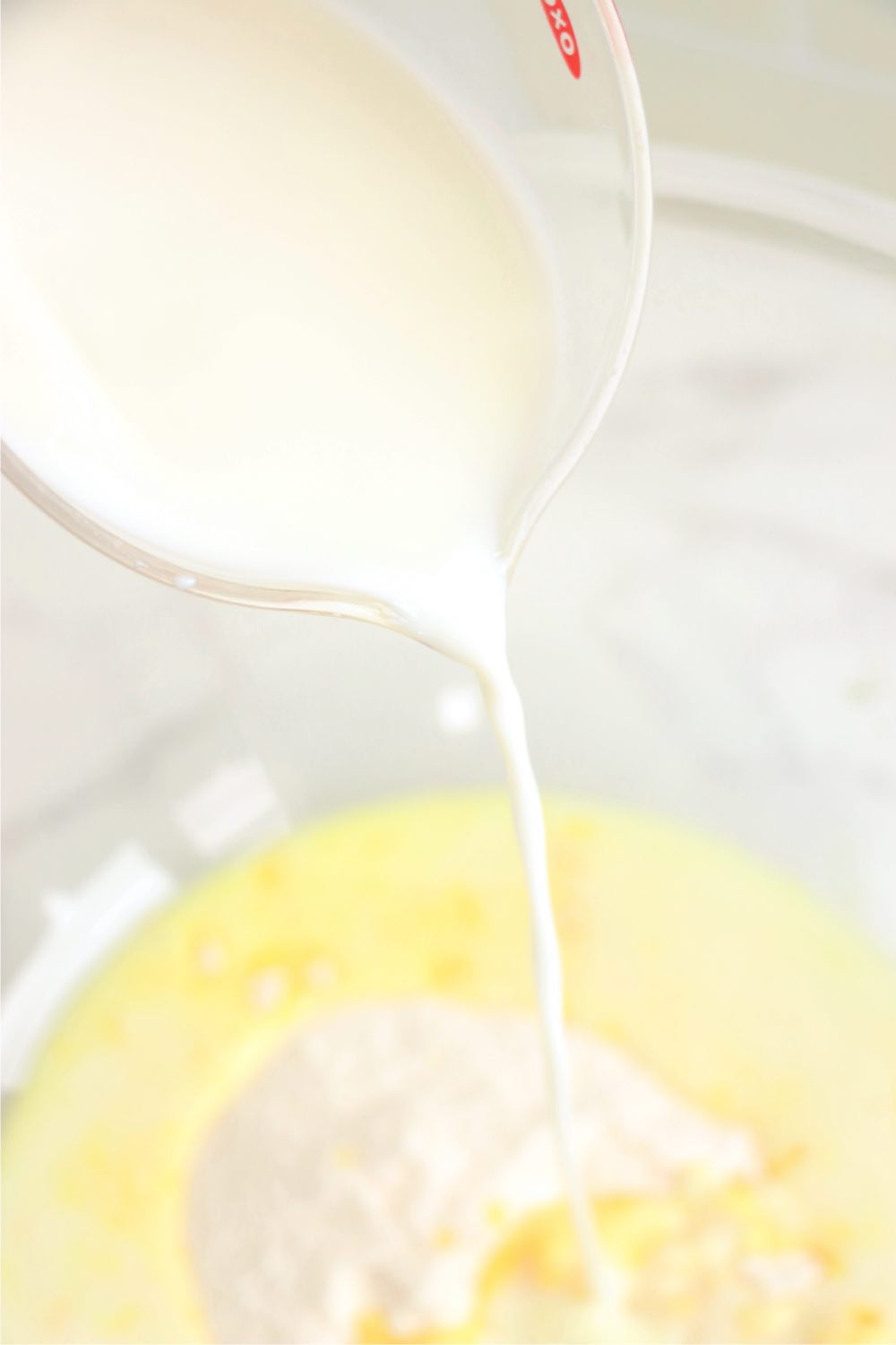 Adding milk to vanilla pudding in a bowl