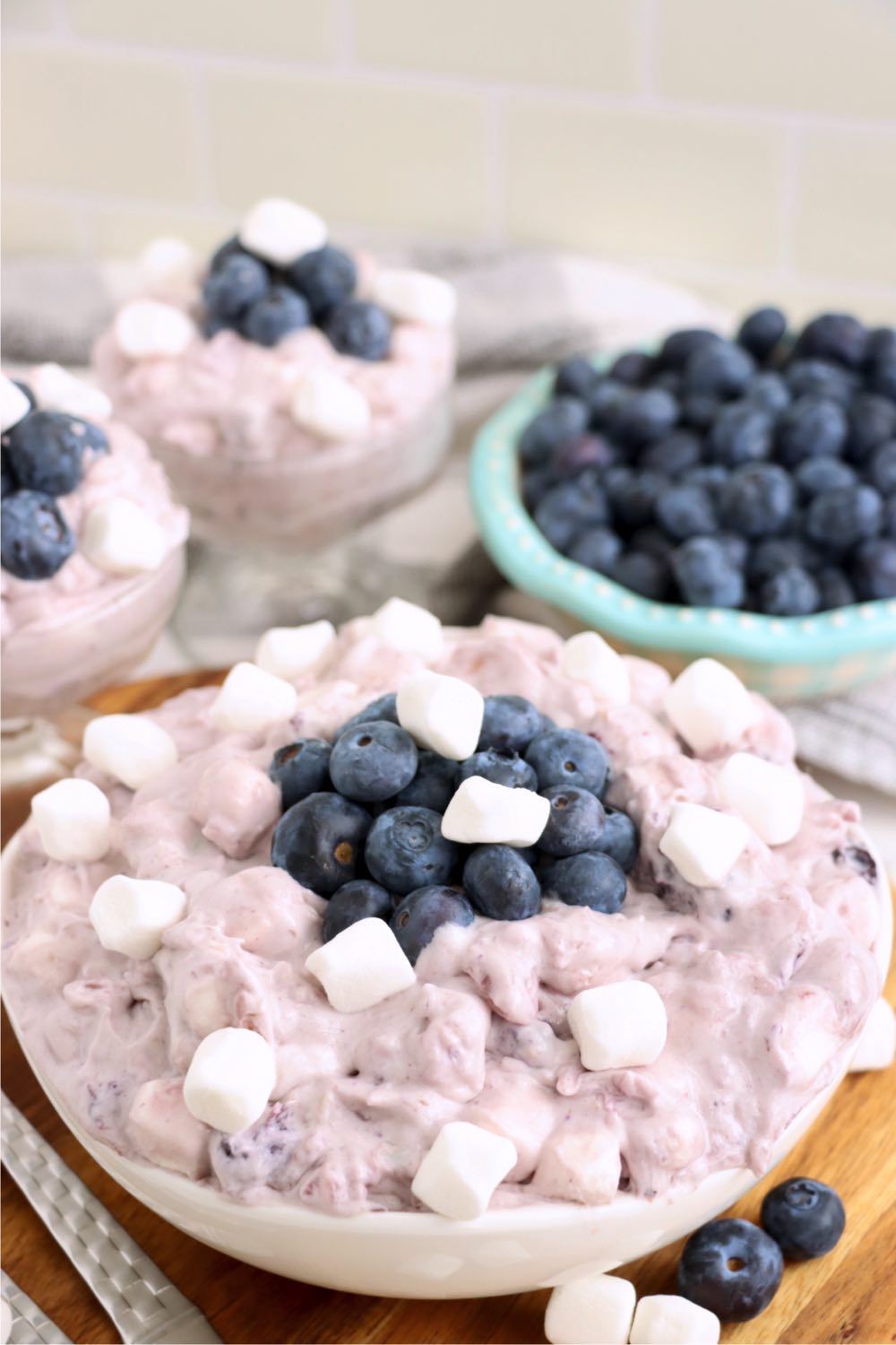 Purple-hued blueberry jello fluff salad with marshmallows and blueberries