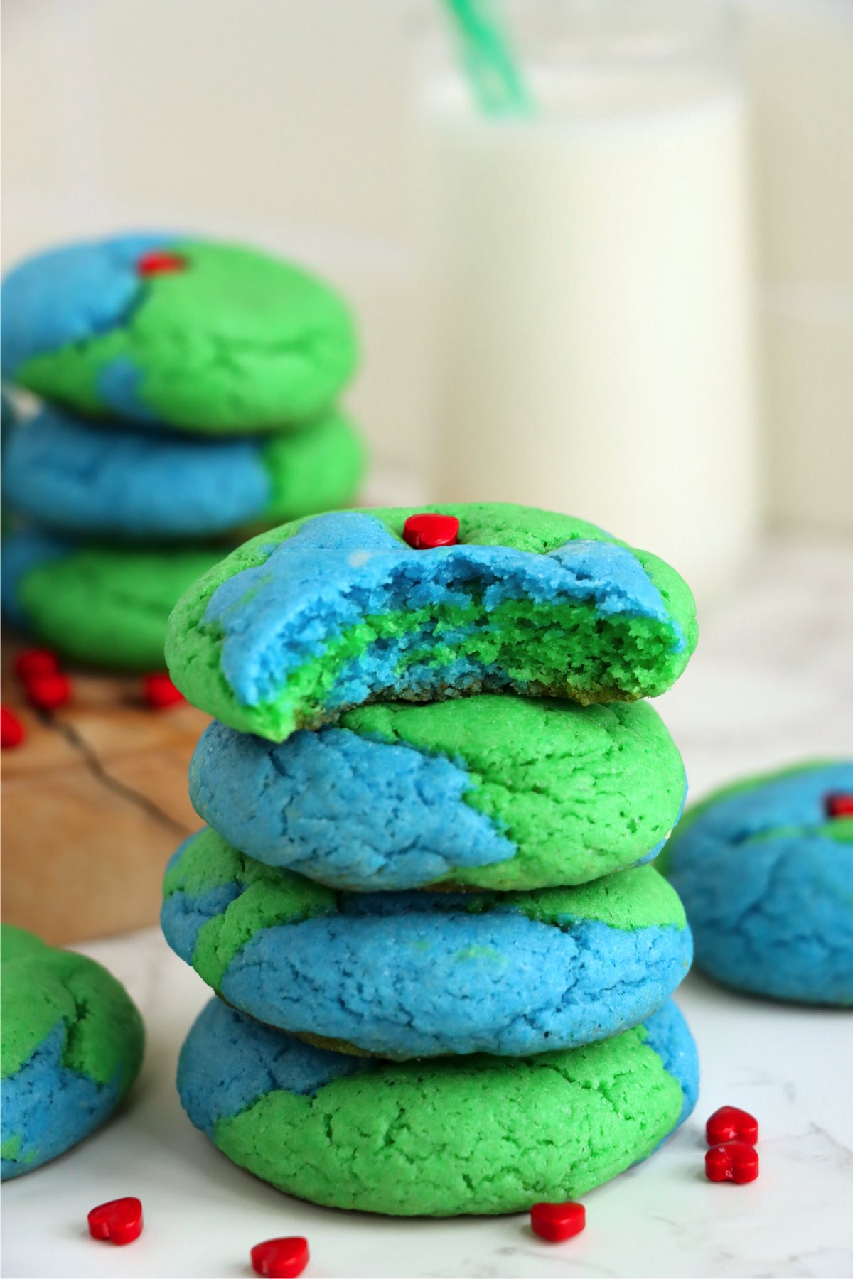 Stack of blue and green cookies with a bite taken out of the top one
