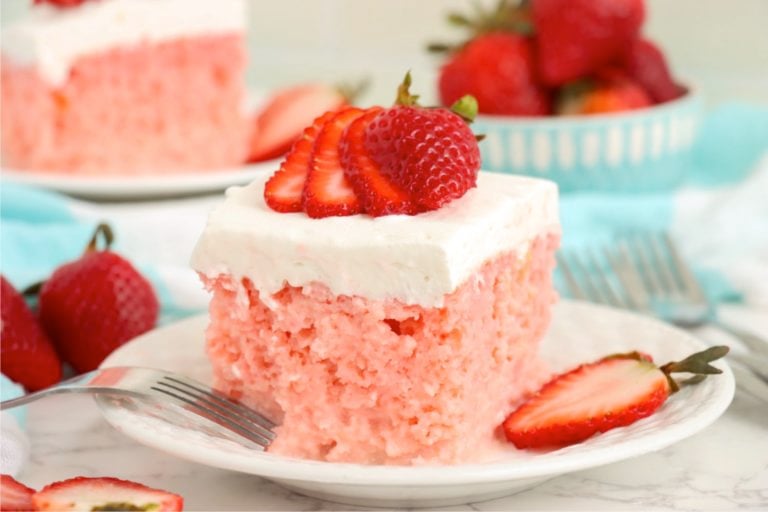 Piece of strawberry cake garnished with fresh strawberries