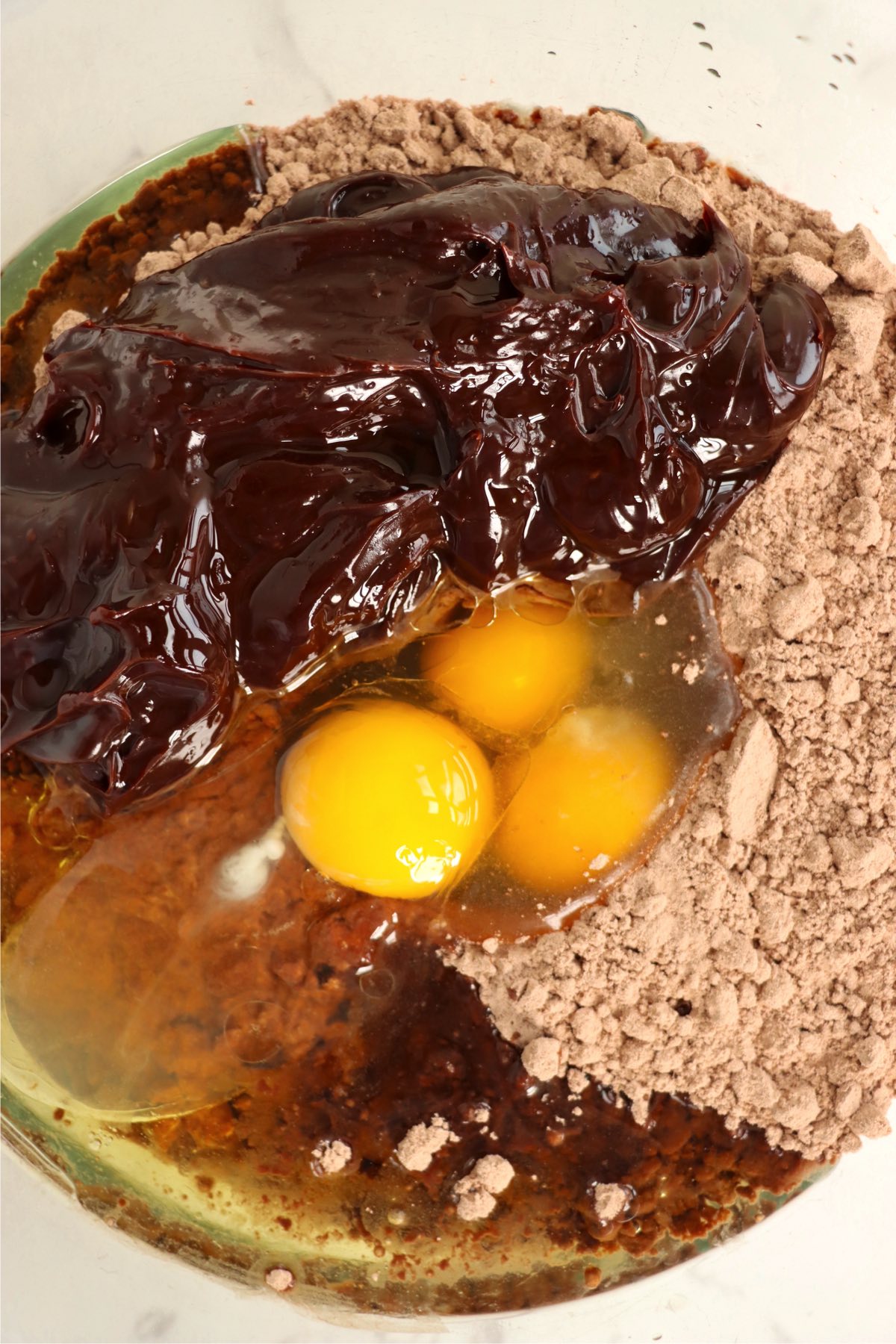 eggs, brownie mix and oil in a glass mixing bowl