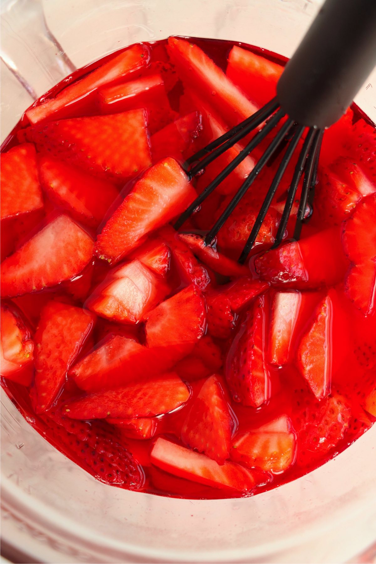Whisking in fresh strawberries to gelatin